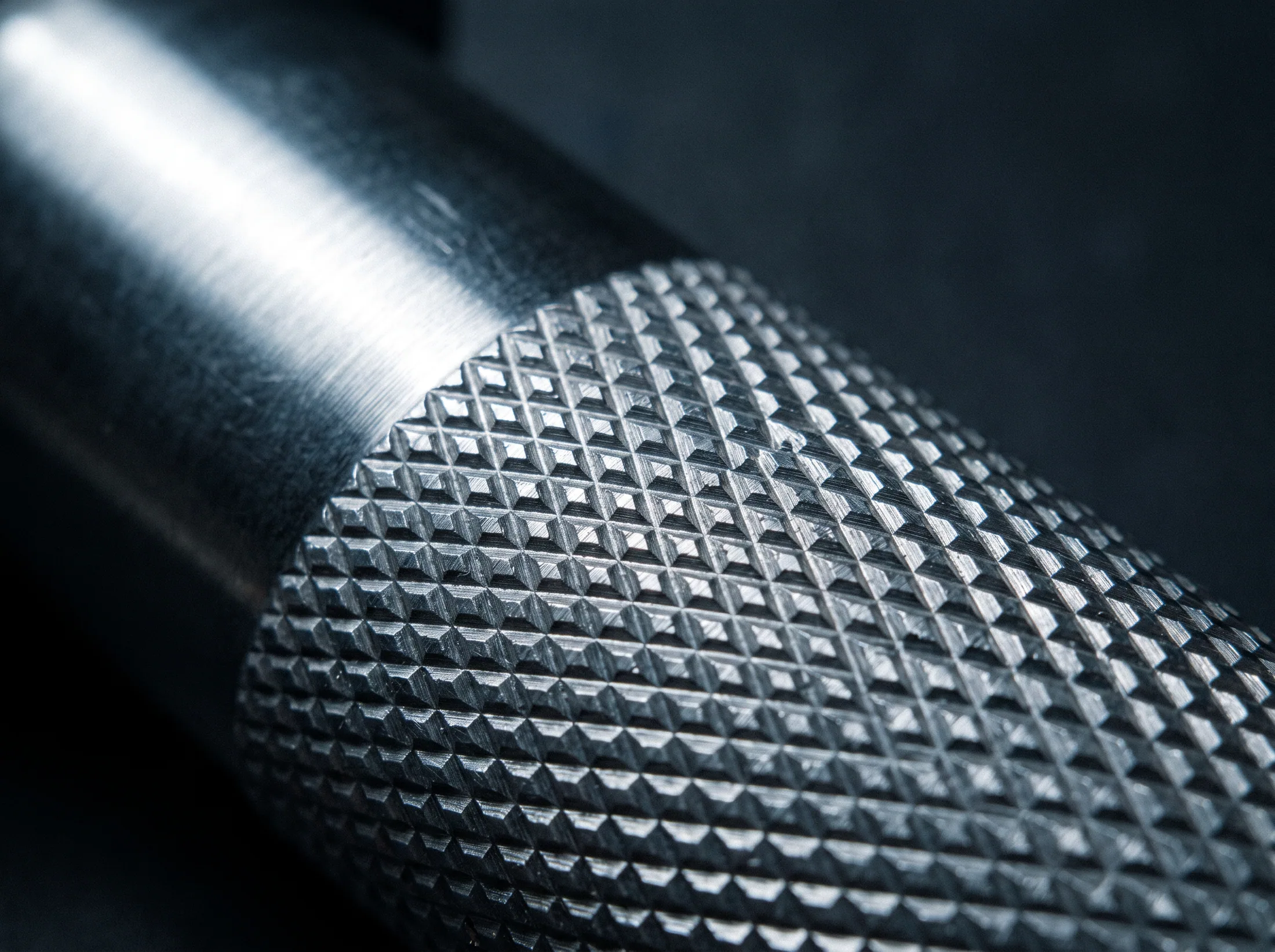 Close detail of knurling on a machined stainless steel hand weight